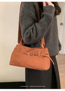 Detail of caramel suede tote bag featuring silver buckle strap and retro texture