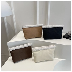 Minimalist plush patchwork clutch handbags in brown, black, and cream leather textures