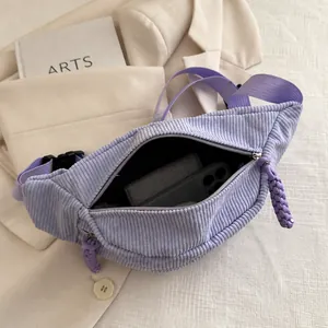 Detailed view of spacious corduroy crossbody bag interior holding essential items