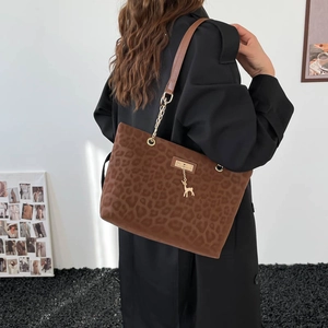 Fashionable leopard print tote bag with gold deer pendant and chain strap detail