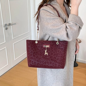 Chic burgundy leopard print tote bag with gold deer charm and chain strap detail