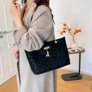 Chic black leopard print tote bag with golden deer charm and chain strap for winter