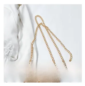 Detailed close-up of the bright gold chain strap and metallic lock on a velvet bag