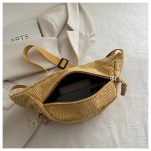 Detail of ginger yellow corduroy crossbody bag showing spacious interior with zipper
