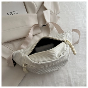Detail view of corduroy fanny pack showing soft fabric texture and inner storage depth
