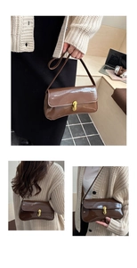 Detail of glossy brown patent leather shoulder bag with elegant golden metal lock