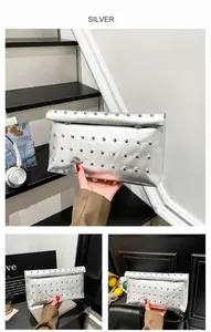 Macro view of silver metallic envelope clutch bag with polished round rivet stud details