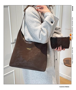 Detail view of deep brown matte tote bag with matching coin purse and golden logo