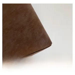 Close-up of premium brown leather texture with natural grain and soft folding details