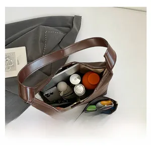 Detailed interior of large brown tote bag showing capacity for tablet and daily items