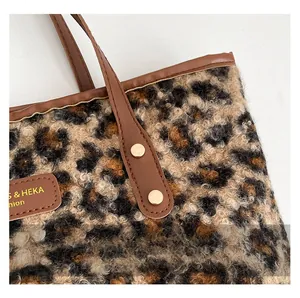 Detail of leopard print tote bag showing fuzzy fabric texture and gold stud accents