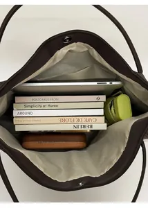Top view of large tote bag interior showing spacious storage for laptop and books