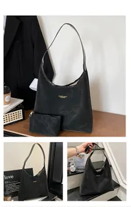 Three-way view of a black leather hobo bag with a small matching zipper coin purse
