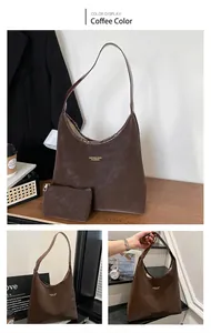 Detail view of coffee-colored oversized tote bag with matching zippered pouch and gold logo