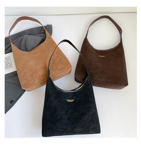 Detailed flat lay of suede hobo bags in black, dark brown, and camel color options