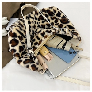 Detailed view of leopard print tote bag interior showing capacity for tablet and umbrella