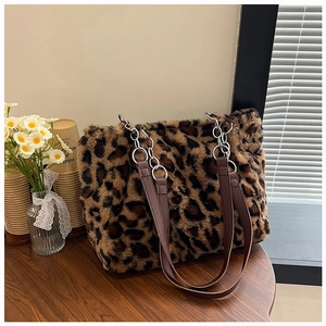 Detail of leopard print faux fur tote bag with metal chain and leather shoulder strap