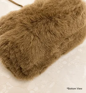 Close-up of the plush brown faux fur texture and bottom detail of the stylish handbag