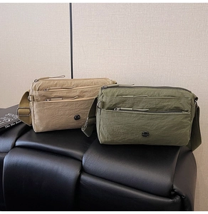 Detailed view of lightweight nylon crossbody bags with multi-zipper layers and metal logo