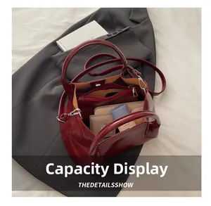 Interior view showing large capacity and inner pouch of the burgundy tote bag