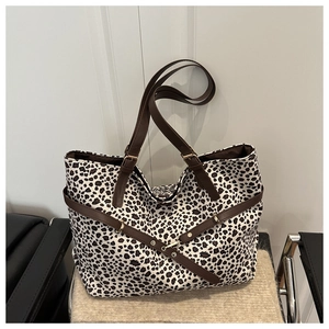 Détail du sac cabas léopard avec anses en cuir synthétique marron et boucles dorées
