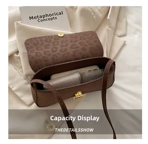 Top view of brown suede underarm bag showing interior capacity and leopard print lining
