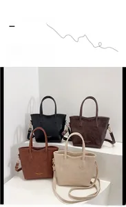 Detail view of leather tote bags in four colors with adjustable shoulder straps