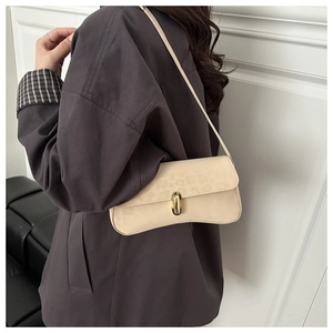 Detail of beige shoulder bag with leopard embossed texture and gold twist lock buckle