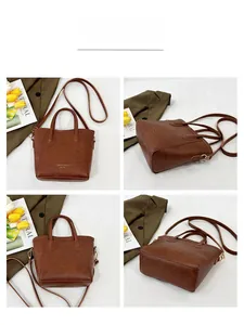 Detail view of deep brown leather bucket bag with top handle and adjustable shoulder strap