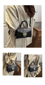 Dettaglio di borsa a trapezio con patta a quadri grigi e chiusura dorata a forma di M