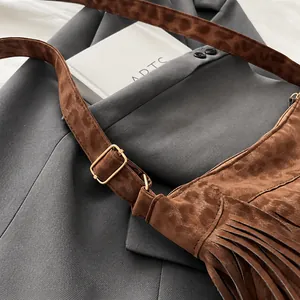 Detail einer Shopper-Tasche mit Leopardenmuster, goldener Schnalle und Quasten-Textur