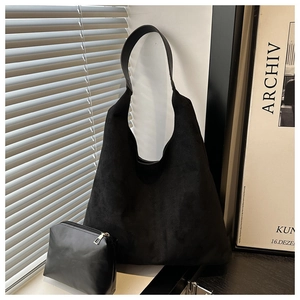 Detail of matte black suede tote bag with wide strap and matching coin purse