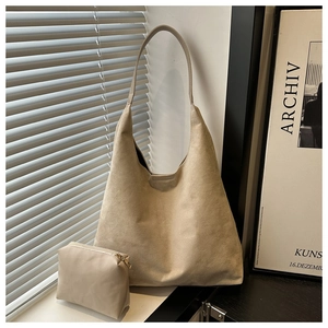 Minimalist beige hobo tote bag set featuring a soft matte finish and matching zipper pouch