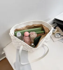 Interior view of white fuzzy tote bag showing spacious capacity with everyday essentials