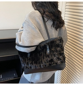 Detail showing plush faux fur and leather contrast on a black tote bag with silver rivets