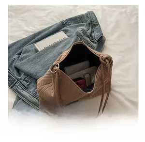 Interior view showing large capacity of the brown textured tote bag with daily items