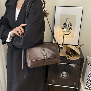 Vintage dark brown faux leather tote bag with metallic buckle and adjustable strap