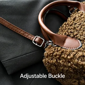 Detail of adjustable metal buckle on brown faux fur handbag with leather strap