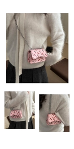 Detail view of pink mini cherry print shoulder bag with silver metal chain strap