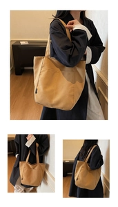 Detail view of khaki canvas tote bag featuring double front pockets and sturdy woven handles