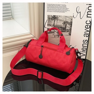Detail of red cylindrical sports duffel bag with durable straps and adjustable buckle