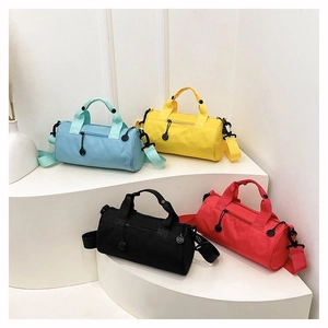 Detailed display of cylinder sports bags in blue, yellow, black and red on white podiums