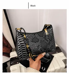 Detail of black snakeskin shoulder bag with textured faux leather and resin chain strap