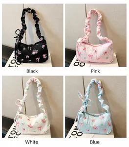 Close-up of floral pleated baguette bags featuring ruffles and bows in four colors