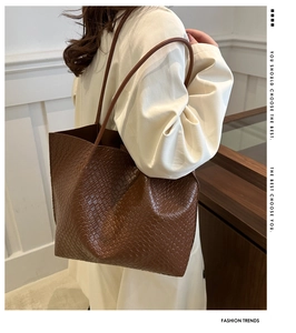 Detailed view of brown woven leather texture on a stylish tote bag for women