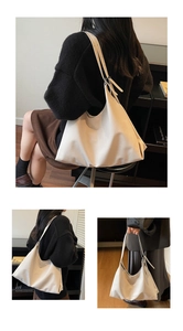 Three-way view of off-white minimalist hobo bag showing large capacity and soft leather texture