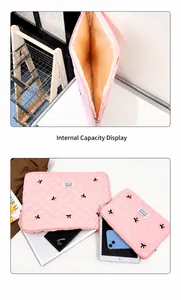 Pink quilted laptop sleeve with black bow embroidery showing internal padding and dual sizes