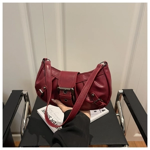 Detailed view of red pleated PU leather hobo bag with vintage metal buckle and handle