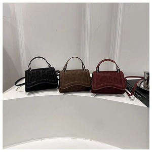 Three leopard texture suede mini crossbody bags in black, coffee, and red on display