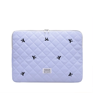 Purple quilted nylon laptop sleeve with bow embroidery and dual zippers for protection